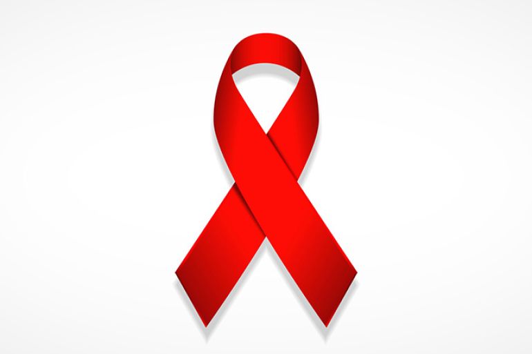 الشريط الأحمر هو شعار عالمي للتوعية بالإيدز ودعم الأشخاص المصابين به, the red ribbon is the universal symbol of awareness and support for those living with HIV.