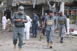 NANGARHAR, AFGHANISTAN - APRIL 18: Members of the Afghan security forces inspect the site of a suicide attack near in Jalalabad City of eastern Nangarhar province of Afghanistan on April 18, 2015. At least 33 people were killed and over 100 injured as suicide bomber detonated his explosive in Jalalabad.