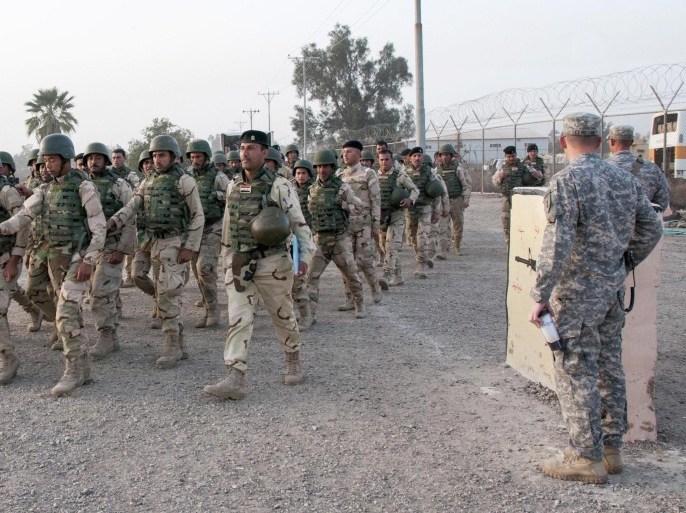 In this Thursday, Feb. 13, 2015 photo released by the U.S. Army, U.S. Army soldiers from the 1st Infantry Division, based at Fort Riley, Kansas, watch as Iraqi army soldiers with the 72nd Brigade march at Camp Taji, north of Baghdad, Iraq. More than 1,400 members of the 72nd Brigade graduated from a six-week training course, assisted by U.S. Soldiers as part of helping combat the Islamic State militant group in Iraq. Iraq's Prime Minister Haider al-Abadi has called on the U.S. and other coalition nations to ramp up support for his country's beleaguered military. (AP Photo/Staff Sgt. Daniel Stoutamire, U.S. Army 1st Infantry Division)