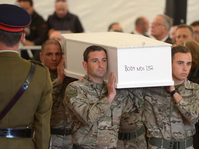 Maltese soldiers hold a coffin during the funeral ceremony of 24 migrants who died after a fishing boat carrying migrants capsized off the Libyan coast, on the helipad at Mater Dei Hospital in Malta on April 23, 2015, as part of an Inter Faith ceremony. Calls have mounted for a military response to the Mediterranean migrant crisis, but experts say such plans are totally unworkable and mark an attempt to militarise what should be a purely humanitarian problem. European leaders will gather in Brussels to discuss new strategies in the wake of the latest disaster on April 19, in which hundreds of migrants drowned when their boat capsized on the way from Libya to Italy. AFP PHOTO / MATTHEW MIRABELLI --- MALTA OUT