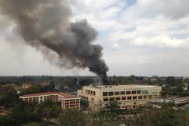FILE - In this Monday, Sept. 23, 2013 file photo, heavy smoke rises after multiple large blasts rocked the Westgate Mall in Nairobi, Kenya. Nairobi has tens of thousands of security guards outside banks, restaurants, malls and homes - but they aren’t armed and when criminals or terrorists attack, they are often the first casualties. (AP Photo/Jerome Delay, File)