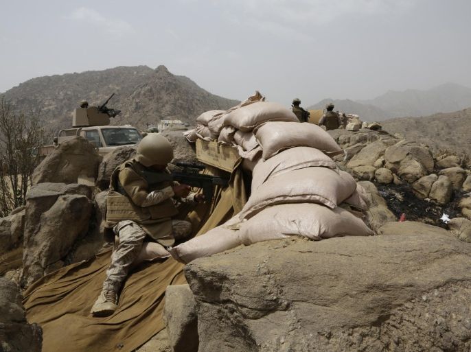 Saudi soldiers on watch from behind sandbag barricade at the border with Yemen in Jazan, Saudi Arabia, Monday, April 20, 2015. The Saudi air campaign in Yemen is now in its fourth week.(AP Photo/Hasan Jamali)
