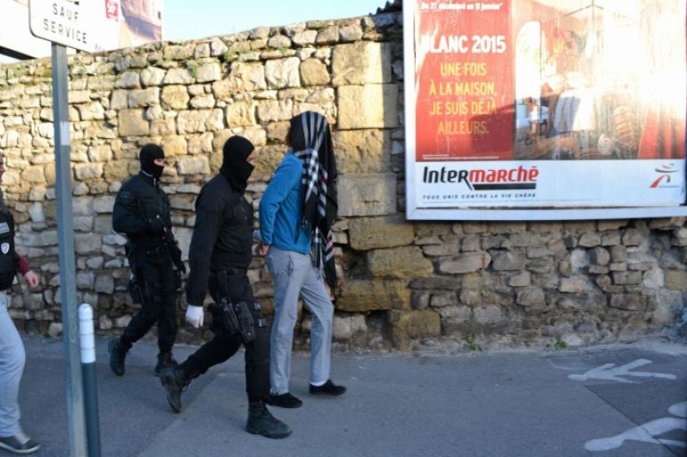 Hooded police officers arrest a suspect during an anti-terrorism operation in Lunel, southern France, Tuesday, Jan. 27, 2015. French security forces have raided a small town in the south that is known as a center for the jihadi recruiting networks that have sent hundreds of French youths to fighting in Syria and Iraq. The raid in the town of Lunel began around dawn on Tuesday. At least six young people from the town of about 27,000 have died in Iraq and Syria in recent months. (AP Photo/ Le Midi Libre) MANDATORY CREDIT NO ARCHIVE