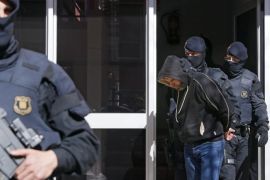 Catalonian regional policemen escort one of the ten men who were arrested during an operation against the Jihadist terrorism carried out in the region of Catalonia, northeastern Spain, 08 April 2015. The ten suspects are accused of being members of a terrorist organisation linked with the Islamic State (IS), police sources said.