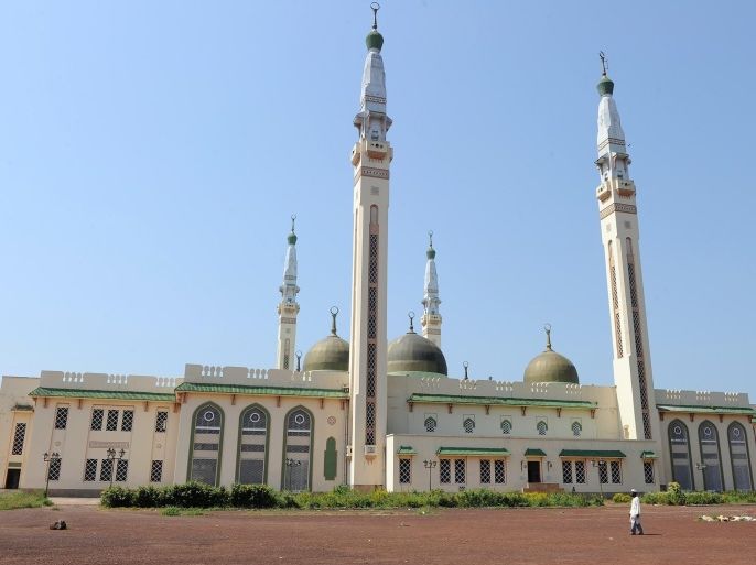 A man walks in front of the Great Mosque on December 2, 2010 in Conakry, as Guinea waited anxiously today for the Supreme Court to confirm presidential election results. Opposition leader Alpha Conde was announced the victor of Guinea's first democratic election since independence on November 15 with 52.5 percent of votes over rival Cellou Dalein Diallo who scored 47.5 percent, sparking accusations of voting fraud.