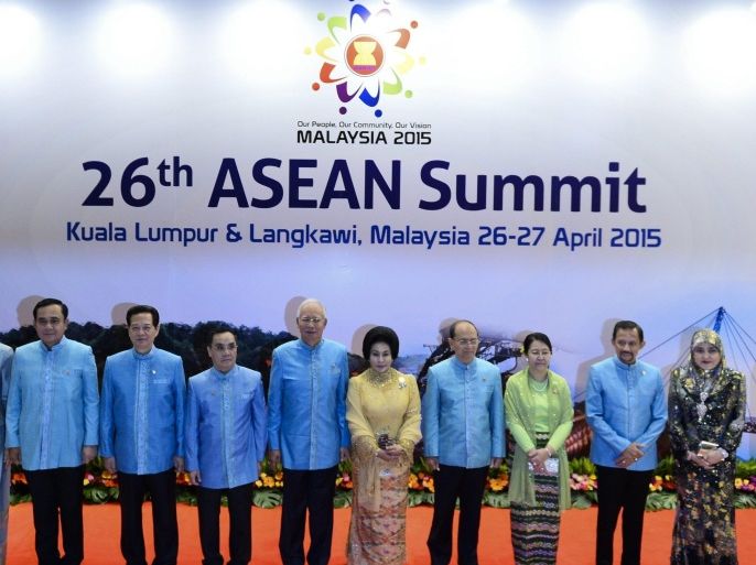 (L-R) Philippine's President Benigno Aquino, Singapore's Prime Minister Lee Hsien Loong, Thailand's Prime Minister Prayut Chan-O-Cha and his wife Naraporn, Vietnam's Prime Minister Nguyen Tan Dung, Laos's Prime Minister Thongsing Thammavong, Malaysia's Prime Minister Najib Razak and his wife Rosmah Mansor, Myanmar's President Thein Sein and his wife Khin Khin Win, Brunei's Sultan Hassanal Bolkiah and his wife Queen Raja Isteri Pengiran Anak Hajah Saleha, Cambodia's Prime Minister Hun Sen and Indonesia President Joko Widodo pose for group photo before the Gala Dinner in honour of ASEAN Heads of State pose for photograph during the 26th ASEAN Summit in Kuala Lumpur on April 26, 2015.The 10-member nation group are focusing on furthering the ASEAN community integration, which will lead to a single market for the south-east Asian region and some members are expected to raise territorial disputes in the South China Sea