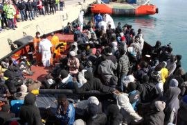 FILE - In this Sunday, Feb. 15, 2015 file photo, migrants wait to disembark from a tug boat after being rescued in the Pozzallo harbor in Sicily, Italy. Africa’s envoy to the European Union warned Wednesday, April 1, 2015 that EU plans to process migrants in the countries they leave or transit on their way to Europe are “a dangerous approach.” (AP Photo/Francesco Malavolta, File)