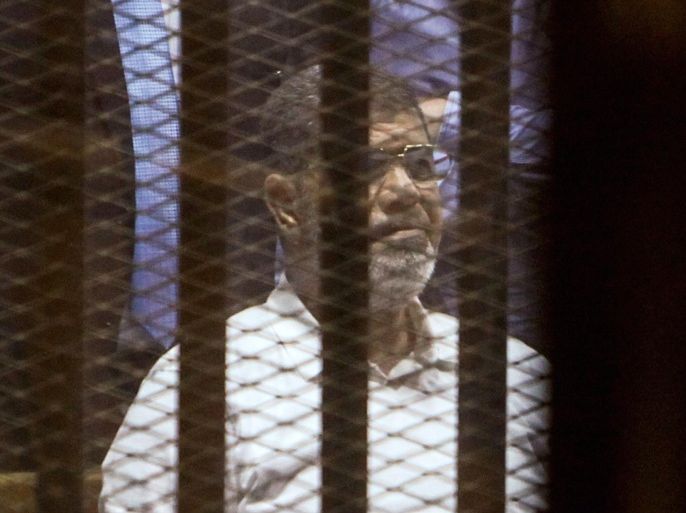 CAIRO, EGYPT - APRIL 21: Egypt's former president Mohammed Morsi looks from behind dock bars during trial session, in Cairo, Egypt on 21 April 2015. An Egyptian court sentenced Mohammed Morsi to 20 years in prison over the killing of protesters during a 2012 demonstration outside the presidential palace in Cairo.