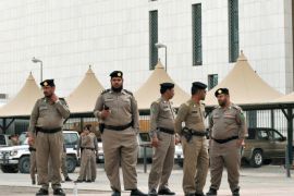 Saudi policemen stand guard in front of the 'Public grievances Department' building in Riyadh on March 11, 2011 as Saudi Arabia launched a massive security operation in a menacing show of force to deter protesters from a planned 'Day of Rage' to press for democratic reform in the kingdom.