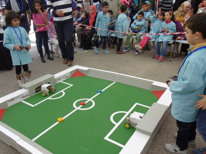 مسابقة روبوتات كرة قدم حظيت بإقبال الأطفال وتشجيع الحضور (الجزيرة)