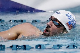 Michael Phelps reaches for the wall as finishes a men's 400-meter freestyle preliminary race, Friday, April 17, 2015, at the Arena Pro Swim Series in Mesa, Ariz. Phelps finished 17th in the preliminaries. (AP Photo/Matt York)