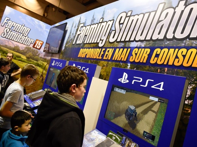 TO GO WITH AFP STORY BY LUCIE GODEAU Children play a farming simulation video game during the Paris international agricultural fair at the Porte de Versailles exhibition center in Paris on February 26, 2015. AFP PHOTO / LOIC VENANCE