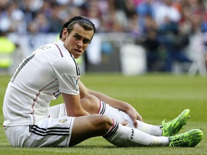 Real Madrid's Welsh midfielder Gareth Bale reacts after picking up an injury during the Spanish Primera Division match between Real Madrid and Malaga at Santiago Bernabeu stadium, in Madrid, Spain 18 April 2015.