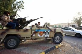 Fighters from the Fajr Libya (Libya Dawn), an alliance of Islamist-backed militias, keep watch in al-Aziziyah, located some 40 kilometres south of the Libyan capital Tripoli, on March 25, 2015. AFP PHOTO / MAHMUD TURKIA