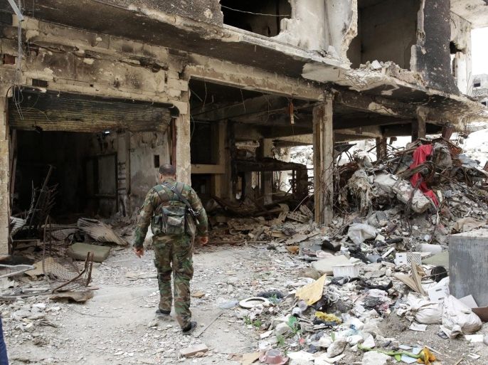 A Palestinian fighter walks through the rubble of the al-Yarmouk Palestinian refugee camp, south of Damascus, Syria, 09 April 2015. Commenting on the the partial occupation of the al-Yarmouk Palestinian Refugee camp 01 April by fighters from the group calling themselves the Islamic State (IS) the Palestinian Minister of Labour stated that there was no option of a political solution to the takeover which has left residents trapped and badly in need of basic supplies.