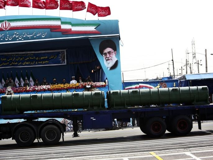 An Iranian military truck carries a Bavar-373 air defence missile system past a portrait of Iran's supreme leader, Ali Khamenei during the Army Day parade in Tehran on April 18, 2015. Russian President Vladimir Putin earlier this week removed the ban on supplying Iran with a more sophisticated S-300 air defence missile system, paving the way to conclude a long-delayed contract as Iran claims the domestically produced Bavar-373 system has similar capabilities to the S-300. AFP PHOTO/BEHROUZ MEHRI