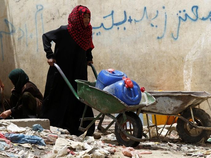 A Yemeni woman pushes a wheelbarrow with jerry cans full of water inside, after she collected them from a philanthropist-provided water tap in Sanaa, Yemen, 07 April 2015. According to reports, many Yemenis were affected by the airstrikes carried out by the Saudi-led coalition against Houthi rebels, as they are facing shortage of water and food. The Red Cross and Russia called for an urgent humanitarian ceasefire to allow medical aid to reach areas hit by the fighting and allow residents safe access to food and water.