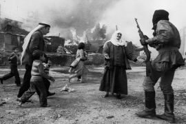 A Palestinain woman pleads with Christian militia in Beirut while a man tries to take children to safety during the Lebanese civil war, 19th January 1976. (Photo by Francoise De Mulder/Roger Viollet/Getty Images)