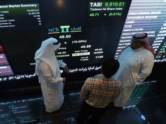 Investors monitor screens displaying stock information at the Saudi Stock Exchange (Tadawul) in Riyadh November 12, 2014. Shares in Saudi Arabia's biggest lender, National Commercial Bank, jumped their daily 10 percent limit upon listing on Wednesday after a $6 billion IPO, the largest ever in the Arab world and the second-biggest globally this year. REUTERS/Faisal Al Nasser (SAUDI ARABIA - Tags: BUSINESS)