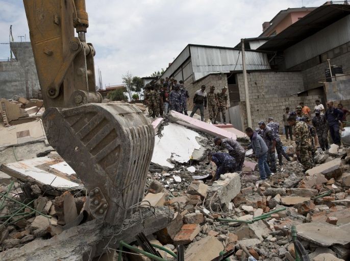 Nepalese security personnel engage themselves in a rescue operation at the site of a budget hotel that collapsed in Saturday’s earthquake, in Kalanki neighbourhood of Kathmandu, Nepal, Sunday, April 26, 2015. A powerful aftershock shook Nepal on Sunday, making buildings sway and sending panicked Kathmandu residents running into the streets a day after a massive earthquake devastated the region and destroyed homes and infrastructure. (AP Photo/Bernat Armangue)