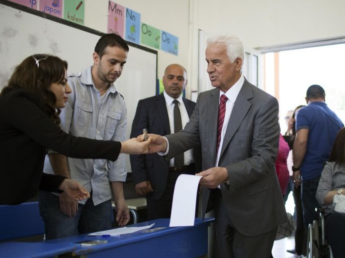 Turkish Cypriot President and candidate for the presidential elections in the self-proclaimed Turkish Republic of Northern Cyprus (TRNC) Dervis Eroglu arrives at a polling station to vote on April 19, 2015 in the eastern port city of Famagusta. The tiny republic, which is only recognised by Turkey, heads to the polls to elect a new leader from seven candidates, including Sibel Siber -- the sole woman candidate, the head of parliament and a former prime minister -- and Mustafa Akinci, an independent. AFP PHOTO / FLORIAN CHOBLET