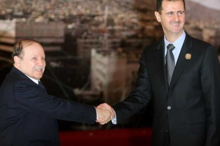 Syrian President Bashar al-Assad (R) shakes hands with his Algerian counterpart Abdelaziz Bouteflika at the opening session of the Arab Summit in Damascus on March 29, 2008. The Syrian President opened a boycott-hit Arab summit today in the absence of half of the region's leaders, many of whom blame Damascus for the political crisis in Lebanon.