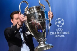 A UEFA logistics employee brings the UEFA Champions League trophy prior to the draw for the UEFA Champions League semi-final football matches at the UEFA headquarters in Nyon on April 24, 2015. AFP PHOTO / FABRICE COFFRINI