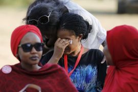 A woman is consoled while a Nigerian protest group continues their sit-in about the girls that are still missing from Chibok, in Abuja, Nigeria April 29, 2015. Nigeria's military said on Wednesday it had transported nearly 300 women and girls rescued from Boko Haram to the hilly border town of Gwoza. The 200 girls and 93 women were freed from four camps during an army operation in northeastern Borno province as the Nigeria military bears down on what are believed to be Boko Haram's final strongholds in the Sambisa forest. The military said on Tuesday initial enquiries suggested the freed women did not include roughly 200 missing schoolgirls seized a year ago from the northern village of Chibok, whose capture drew global attention to the insurgency in Nigeria. REUTERS/Afolabi Sotunde