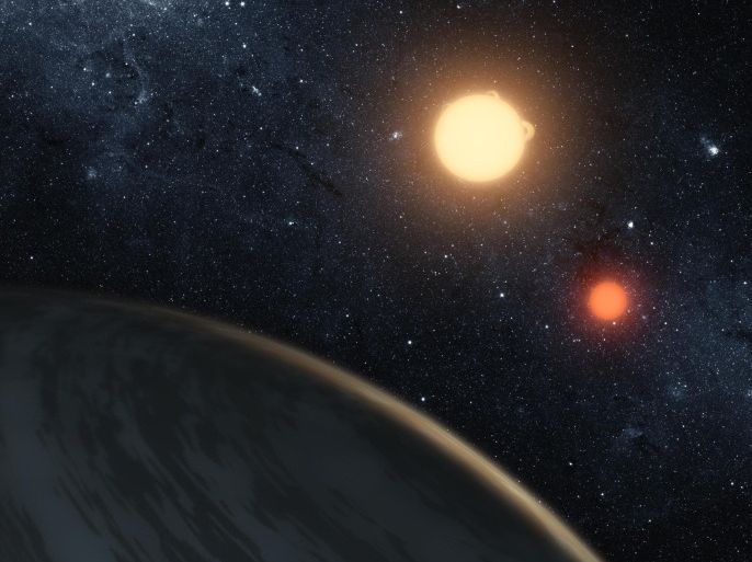 NASA handout image shows an artist's concept of the circumbinary planet Kepler-16b - the first planet known to definitively orbit two stars. The cold planet, with its gaseous surface, is not thought to be habitable. The largest of the two stars, a K dwarf, is about 69 percent the mass of our sun, and the smallest, a red dwarf, is about 20 percent the sun's mass. These star pairs are called eclipsing binaries.