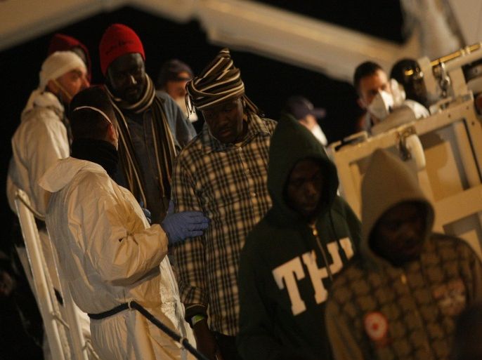 Migrants disembark from a ship of the Italian coast guards on March 4, 2015 in the port of Augusta, Sicily, after a rescue operation off the coast of Sicily yesterday as part of the Triton plan (Frontex). A boat capsized off Sicily when the migrants aboard rushed to meet rescuers, killing at least 10 people, the Italian coastguard said on March 3, 2015 'The migrants, as they frequently do, all rushed to one side of the boat which then capsised,' Italian coast guard spokesman Filippo Marini told TV station SkyTG24, adding many of the passengers did not know how to swim. Hundreds of people have died in recent months as waves of migrants from North Africa and Middle East conflict zones attempt to reach Europe, prompting criticism of rescue efforts. AFP PHOTO / MARCELLO PATERNOSTRO