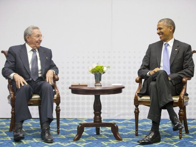 In this Saturday, April 11, 2015 photo, U.S. President Barack Obama, right, smiles as he looks over towards Cuban President Raul Castro, left, during their historic meeting, at the Summit of the Americas in Panama City, Panama. The leaders of the United States and Cuba held their first formal meeting in more than half a century on Saturday, clearing the way for a normalization of relations that had seemed unthinkable to both Cubans and Americans for generations. (AP Photo/Pablo Martinez Monsivais)