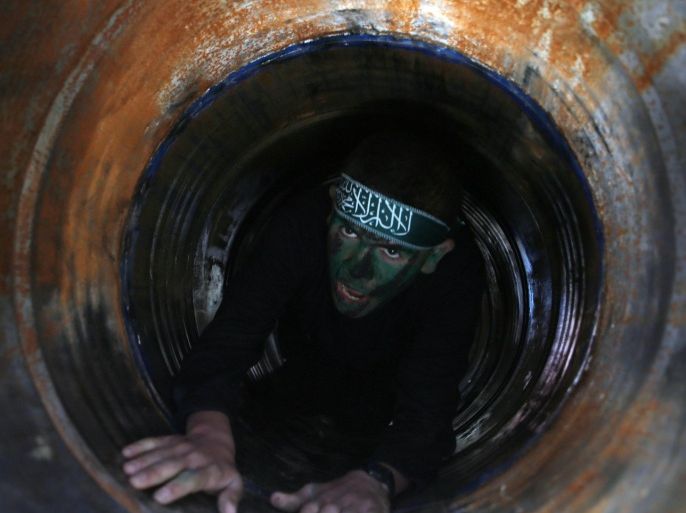 A Palestinian youth crawls in a tunnel during a graduation ceremony for a training camp run by the Hamas movement on January 29, 2015 in Khan Yunis, in the southern Gaza Strip. AFP PHOTO / SAID KHATIB