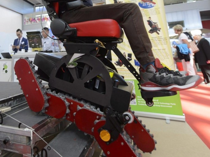 A man from China present the invention B-Free Chair, an all terrain multi-function stair-climbing power wheelchair, at the 43th International Exhibition of Inventions, New Techniques and Products, in Geneva, Switzerland, 15 April 2015. Some 700 exhibitors from around the world are presenting around 1,000 products hoping to catch the eye at the 43th International Exhibition of Inventions, which runs from 15 to 19 April.