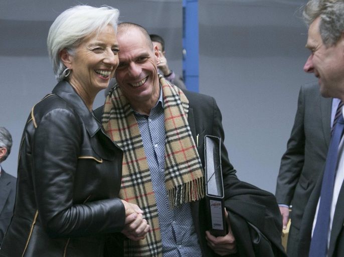 Greek Finance minister Yanis Varoufakis (R) talks with International Monetary Fund Managing Director Christine Lagarde (L) during an extraordinary euro zone Finance Ministers meeting to discuss Athens' plans to reverse austerity measures agreed as part of its bailout, in Brussels February 11, 2015. Varoufakis began tense talks with euro zone finance ministers on Wednesday after his new leftist-led government won a parliamentary confidence vote for its refusal to extend an international bailout. REUTERS/Yves Herman (BELGIUM - Tags: POLITICS BUSINESS)