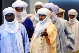 The vice president of the Tuareg National Movement for the Liberation of Azawad (MNLA), Mahamadou Djeri Maiga (C-L), arrives for a meeting on peace talks, attended by Mali's various warring factions for the first time since an interim agreement in June 2013, on July 16, 2014 in the Algerian capital Algiers. The Bamako government is ready to make concessions within its 'red lines' to clinch an accord with armed groups from northern Mali, Diop said, as peace talks began in Algiers. Those red lines include 'respect for territorial unity, the unity of Mali and the republican form of the Malian state,' he added. AFP PHOTO/FAROUK BATICHE