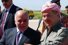 Iraqi Prime Minister Hadier al-Abadi (L) is welcomed by Iraqi Kurdish leader Massud Barzani following his arrival at the airport in Arbil, the capital of the autonomous Kurdish region of northern Iraq, on April 6, 2015. AFP PHOTO / SAFIN HAMED