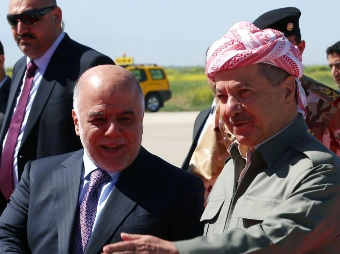 Iraqi Prime Minister Hadier al-Abadi (L) is welcomed by Iraqi Kurdish leader Massud Barzani following his arrival at the airport in Arbil, the capital of the autonomous Kurdish region of northern Iraq, on April 6, 2015. AFP PHOTO / SAFIN HAMED
