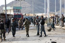 Afghan security personnel gather at the site of a suicide attack in Kabul, Afghanistan, Friday, April 10, 2015. In the capital, Kabul, a suicide bomber in a car targeted armored vehicles, wounding two civilians, according to Farid Afzali Kabul, the head of the Kabul police's criminal investigation unit. The Taliban claimed responsibility. (AP Photo/Rahmat Gul)