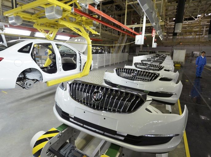 An employee looks on next to an assembly production line of Buick cars at a General Motors factory in Wuhan, Hubei province January 28, 2015. China plans to cut its growth target to around 7 percent in 2015, its lowest goal in 11 years, sources said, as policymakers try to manage slowing growth, job creation and pursuing reforms intended to make the economy more driven by market forces. Picture taken January 28, 2015. REUTERS/Stringer (CHINA - Tags: BUSINESS TRANSPORT) CHINA OUT. NO COMMERCIAL OR EDITORIAL SALES IN CHINA