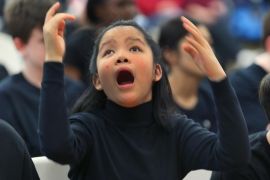 RANDOLPH, MA - DECEMBER 19: Hope Knowlton, 12, has autism and expresses herself as she listens to a the song 'Someday at Christmas' being performed on stage by the chorus group during the Boston Higashi School's annual Winter Music Festival. The school serves children and young adults with autism. Hope's father said that she loves music. Nearly every student took part in the program.