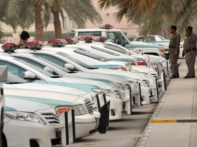 Saudi police cars are parked and policemen stand guard in front of 'Al-rajhi mosque' in central Riyadh on March 11, 2011 as Saudi Arabia launched a massive security operation in a menacing show of force to deter protesters from a planned 'Day of Rage' to press for democratic reform in the kingdom.