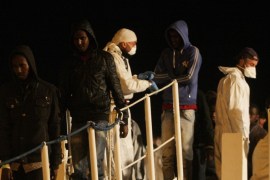 Migrants disembark from a ship on March 4, 2015 in the port of Augusta, Sicily, after a rescue operation off the coast of Sicily yesterday as part of the Triton plan (Frontex). A boat capsized off Sicily when the migrants aboard rushed to meet rescuers, killing at least 10 people, the Italian coastguard said on March 3, 2015 'The migrants, as they frequently do, all rushed to one side of the boat which then capsised,' Italian coast guard spokesman Filippo Marini told TV station SkyTG24, adding many of the passengers did not know how to swim. Hundreds of people have died in recent months as waves of migrants from North Africa and Middle East conflict zones attempt to reach Europe, prompting criticism of rescue efforts. AFP PHOTO / MARCELLO PATERNOSTRO