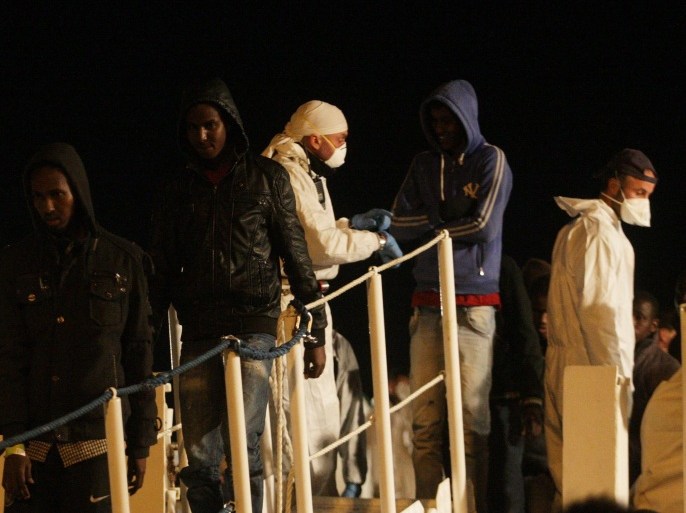Migrants disembark from a ship on March 4, 2015 in the port of Augusta, Sicily, after a rescue operation off the coast of Sicily yesterday as part of the Triton plan (Frontex). A boat capsized off Sicily when the migrants aboard rushed to meet rescuers, killing at least 10 people, the Italian coastguard said on March 3, 2015 'The migrants, as they frequently do, all rushed to one side of the boat which then capsised,' Italian coast guard spokesman Filippo Marini told TV station SkyTG24, adding many of the passengers did not know how to swim. Hundreds of people have died in recent months as waves of migrants from North Africa and Middle East conflict zones attempt to reach Europe, prompting criticism of rescue efforts. AFP PHOTO / MARCELLO PATERNOSTRO