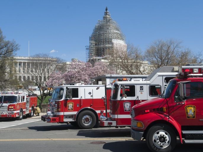 DC Fire Department respond to reports of a shooting at the US Capitol in Washington, DC, April 11, 2015. Shots were fired near the steps of the US Capitol Saturday leading to a lockdown of the building, police said, adding that the threat had been 'neutralized.' US Capitol Police told AFP that the shooting took place on the western side of the building and that officers are investigating a suspicious package on a nearby terrace. Police did not provide details on the shooting, but said a 'threat' had been 'neutralized.' AFP PHOTO / SAUL LOEB
