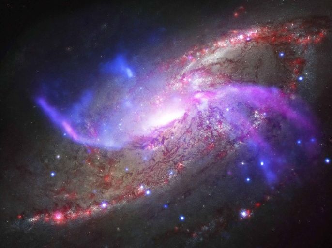 The spiral galaxy NGC 4258, also known as M106, has two extra spiral arms as seen in this undated composite image X-ray data from NASA�s Chandra X-ray Observatory, radio data from the NSF�s Karl Jansky Very Large Array, optical data from NASA�s Hubble Space Telescope and infrared data from NASA�s Spitzer Space Telescope. The image was published in the June 20, 2014 issue of The Astrophysical Journal Letter. REUTERS/NASA/Handout via Reuters (UNITED STATES - Tags: SCIENCE TECHNOLOGY) ATTENTION EDITORS - THIS PICTURE WAS PROVIDED BY A THIRD PARTY. REUTERS IS UNABLE TO INDEPENDENTLY VERIFY THE AUTHENTICITY, CONTENT, LOCATION OR DATE OF THIS IMAGE. THIS PICTURE IS DISTRIBUTED EXACTLY AS RECEIVED BY REUTERS, AS A SERVICE TO CLIENTS. FOR EDITORIAL USE ONLY. NOT FOR SALE FOR MARKETING OR ADVERTISING CAMPAIGNS