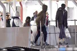 Survivors of the boat that overturned off the coasts of Libya Saturday, disembark from Italian Coast Guard ship Bruno Gregoretti, at Catania Harbor, Italy, Monday, April 20, 2015. A smuggler's boat crammed with hundreds of people overturned off Libya's coast as rescuers approached, causing what could be the Mediterranean's deadliest known migrant tragedy and intensifying pressure on the European Union Sunday to finally meet demands for decisive action. (AP Photo/Carmelo Imbesi)