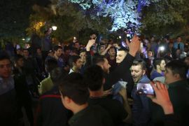 Iranians celebrate a framework agreement on Iran's nuclear program between their country and six world powers, in a street in Tehran, Iran, Friday, April 3, 2015. For the second consecutive night in Tehran, hundreds of Iranians celebrated the deal in major streets and squares. Carrying flags of Iran, singing and dancing, many chanted in support to President Hassan Rouhani and Foreign Minister Mohammad Javad Zarif. (AP Photo/Vahid Salemi)