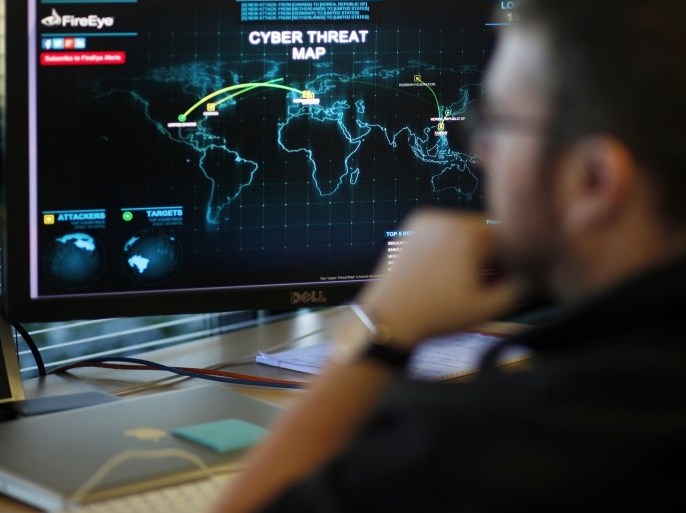 A FireEye information analyst works in front of a screen showing a near real-time map tracking cyber threats at the FireEye office in Milpitas, California, December 29, 2014. FireEye is the security firm hired by Sony to investigate last month's cyberattack against Sony Pictures. Picture taken December 29. REUTERS/Beck Diefenbach (UNITED STATES - Tags: BUSINESS SCIENCE TECHNOLOGY CRIME LAW)