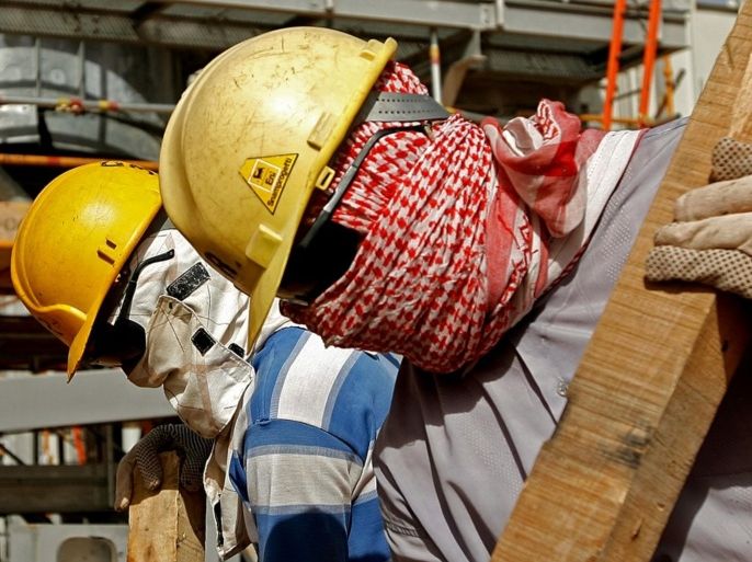 Foreign workers, covering their faces from dust and the blazing sun, work inside the Khouris central processiong oil facility that is still under construction in Saudi Arabia's desert, 160 kms east of the capital Riyadh, on June 23, 2008. Oil producers are at war with speculators but they have been left speculating themselves over the future of their precious commodity after the weekend's unique summit, analysts said. Most experts agree the only concrete result was Saudi Arabia's announcement that it was increasing daily production by more than 200,000 barrels to 9.7 million -- and that it could significantly step this up if necessary.