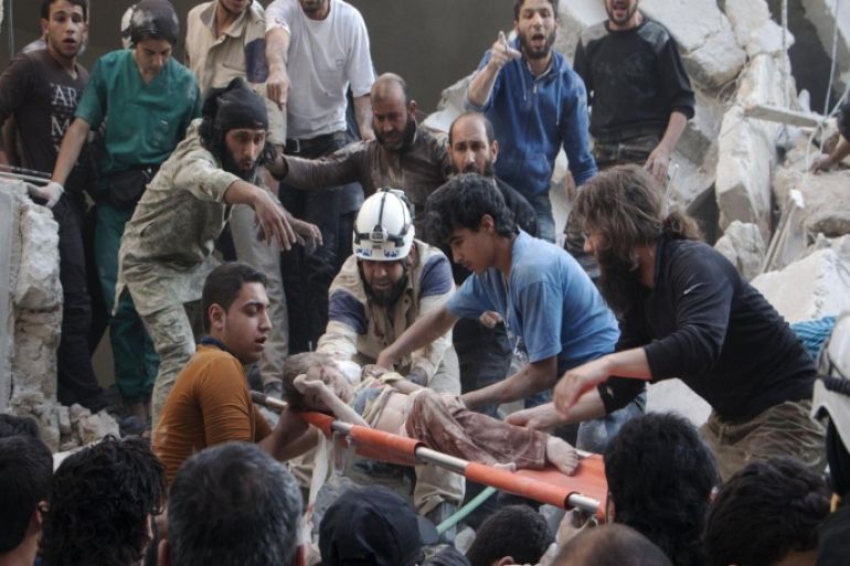 Syrian rescue workers and citizens carry a child on a stretcher from a building following a reported barrel bomb attack by Syrian government forces at the Al-Firdaws neighbourhood of the northern Syrian city of Aleppo, on May 30, 2015. Barrel bombs dropped from regime helicopters killing more than 70 civilians in Aleppo, while government forces in neighbouring Iraq retook an area west of the jihadist-controlled city of Ramadi. AFP PHOTO / KARAM AL-MASRI